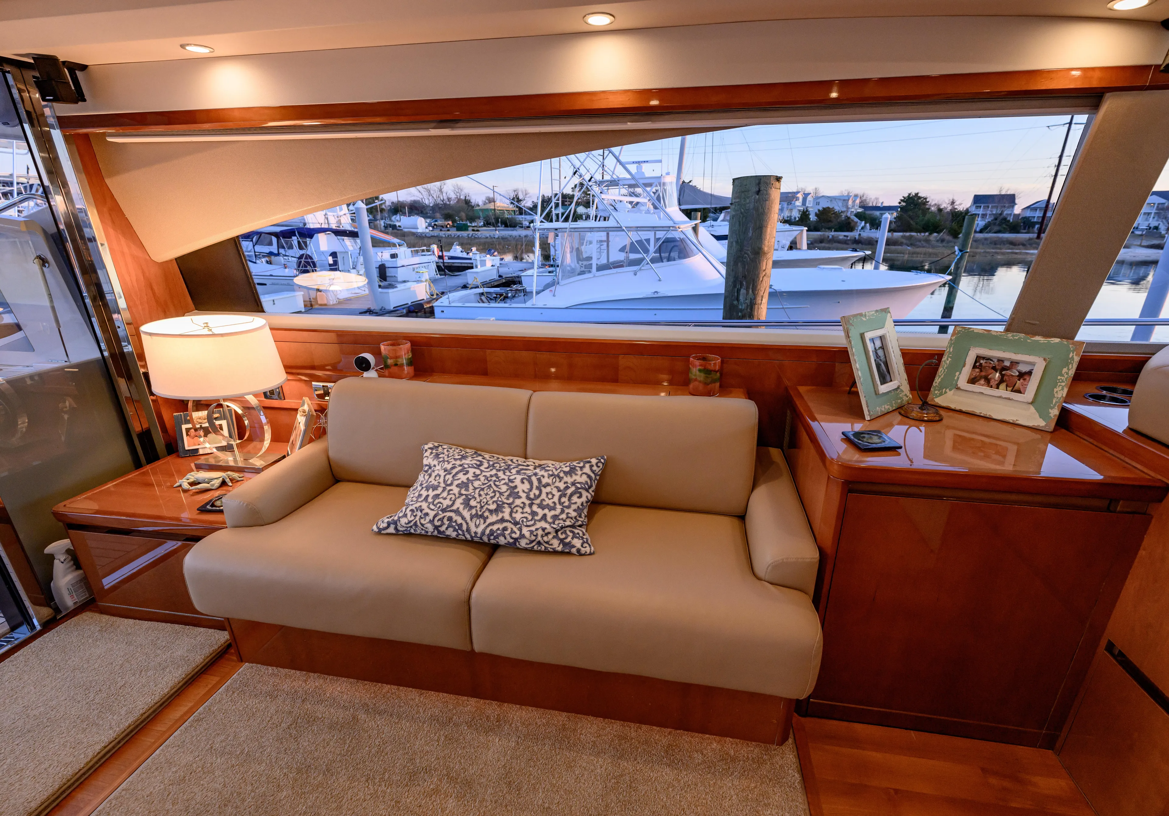 Endless Summer Yacht Photos Pics Luxurious interior of 2006 Princess V65 yacht with elegant sofa and marina view.
