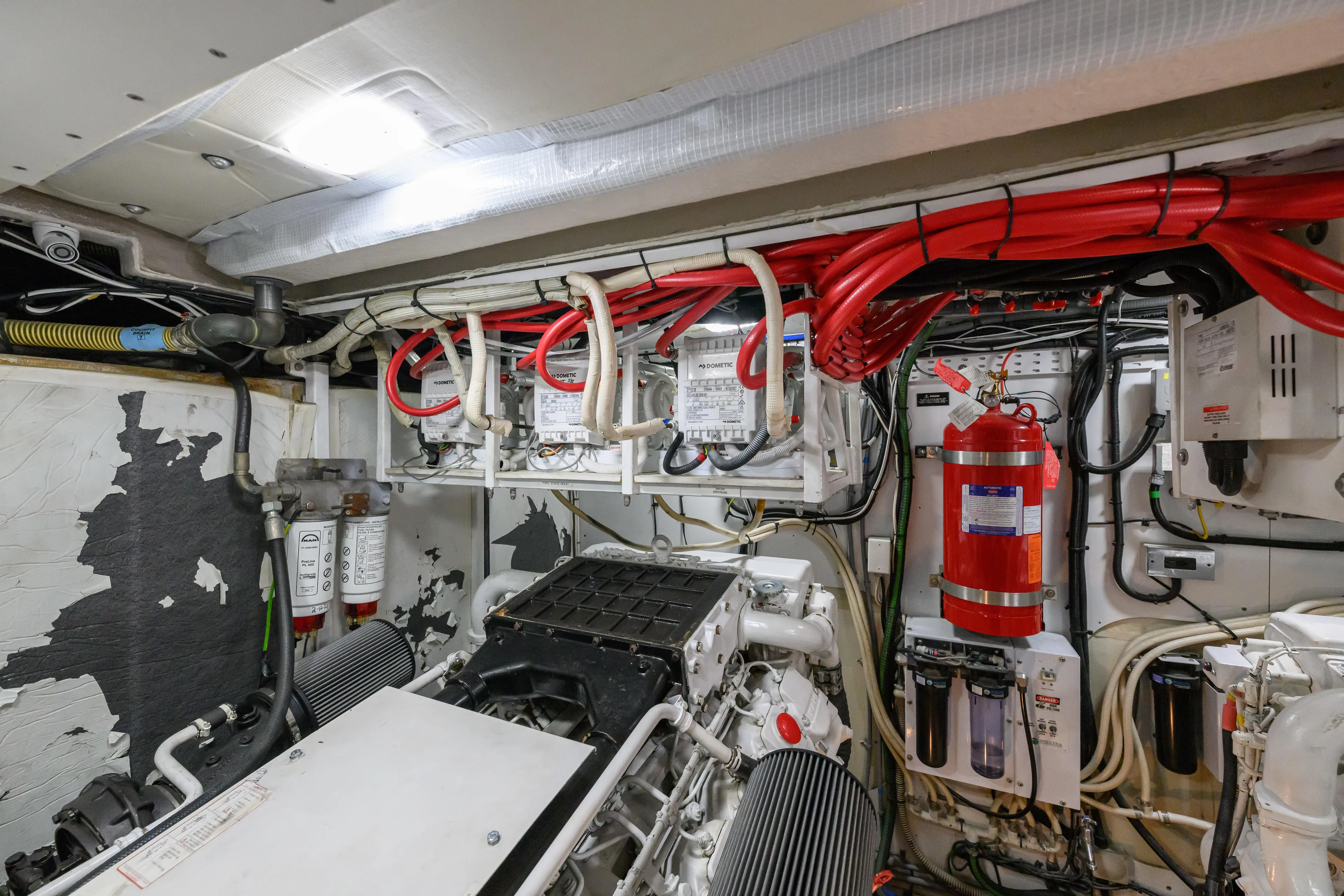 Endless Summer Yacht Photos Pics Engine room of a 2006 Princess V65 yacht, featuring wiring and equipment.