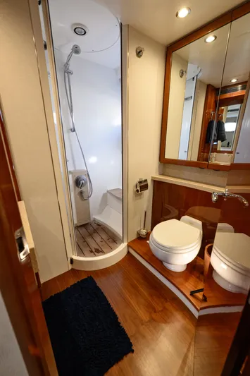 Endless Summer Yacht Photos Pics Luxurious bathroom in a 2006 Princess V65 yacht, featuring a shower and modern fixtures.