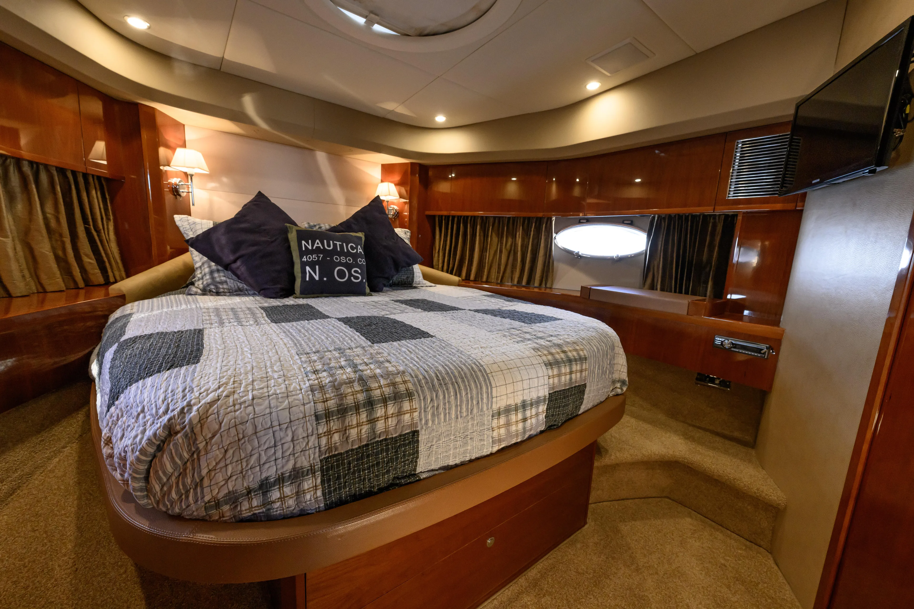 Endless Summer Yacht Photos Pics Luxurious bedroom interior of 2006 Princess V65 yacht with cozy bedding and elegant lighting.