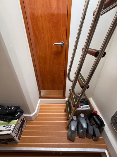 Endless Summer Yacht Photos Pics Interior of 2006 Princess V65 yacht with wooden flooring and metal ladder.