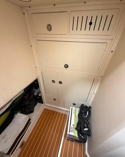 Endless Summer Yacht Photos Pics Interior storage area of a 2006 Princess V65 yacht with wooden flooring.