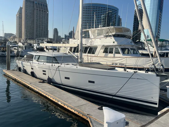 Crosswind Yacht Photos Pics Moody 54 DS 2016 yacht docked in a marina with city skyline background.