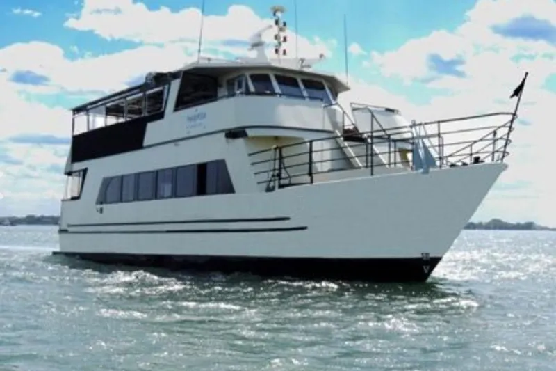 Klancy II Yacht Photos Pics 1989 Kanter 66 yacht cruising on open water under a bright sky.