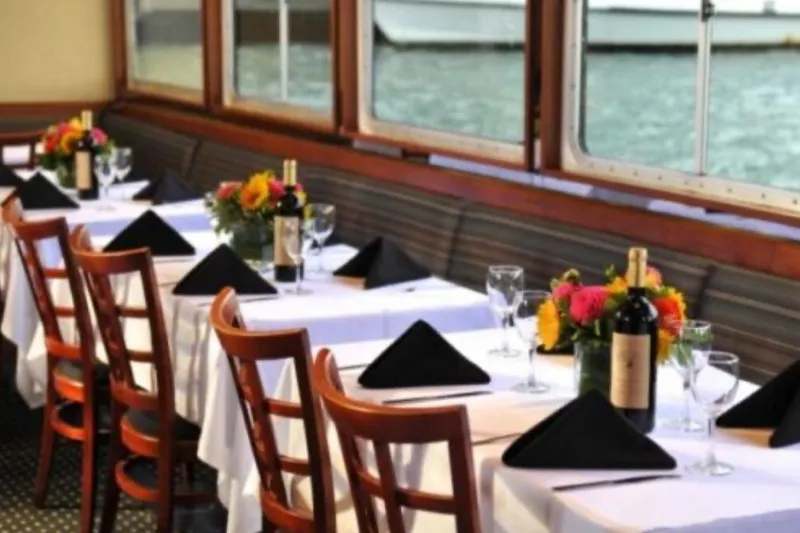Klancy II Yacht Photos Pics Elegant dining setup on a Kanter 66 yacht, featuring wine and floral centerpieces.