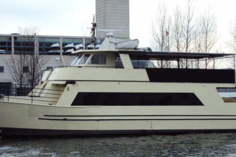 Klancy II Yacht Photos Pics 1989 Kanter 66 yacht docked near industrial buildings and bare trees.