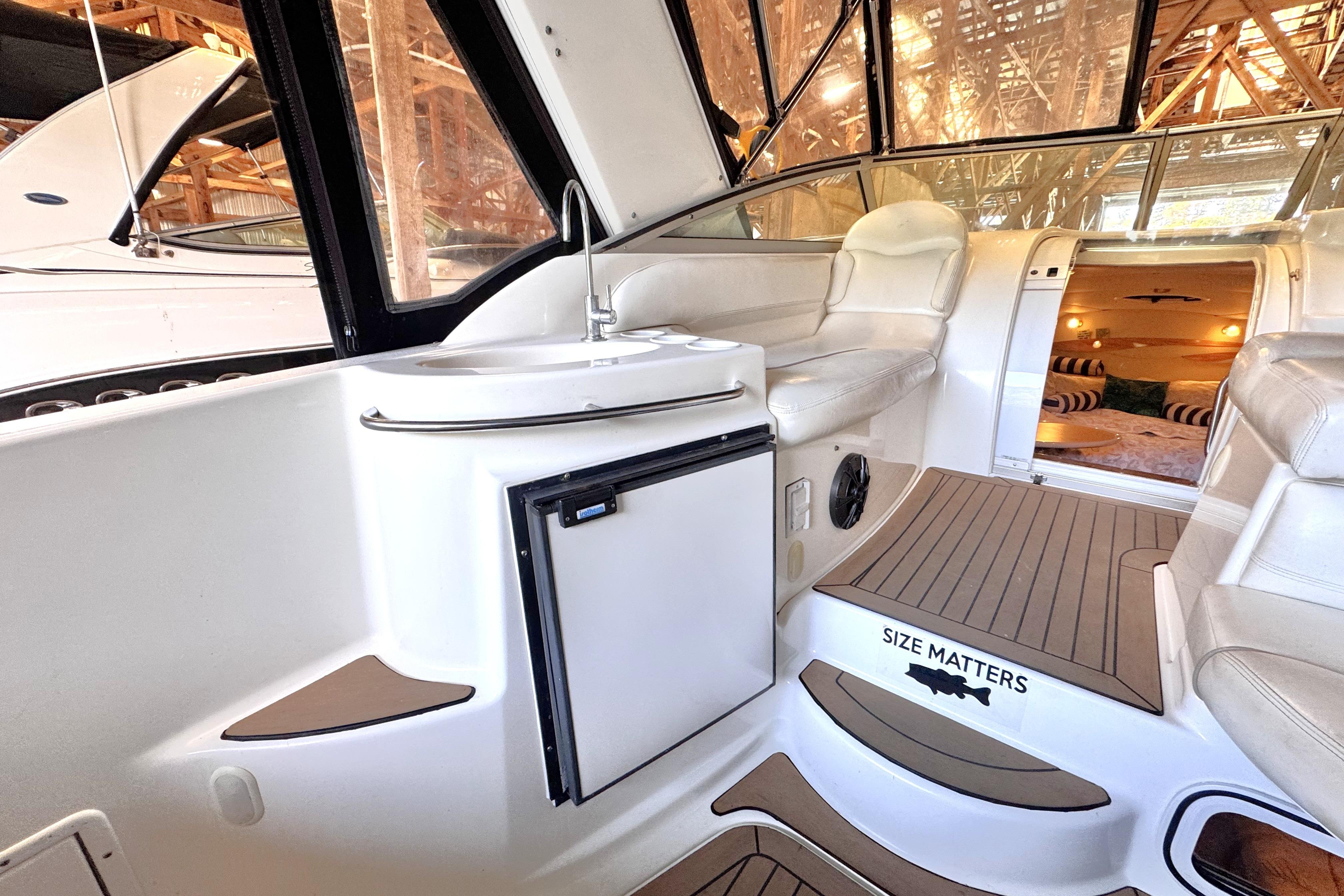 2002 Larson Cabrio 310 boat interior with kitchenette and seating area.