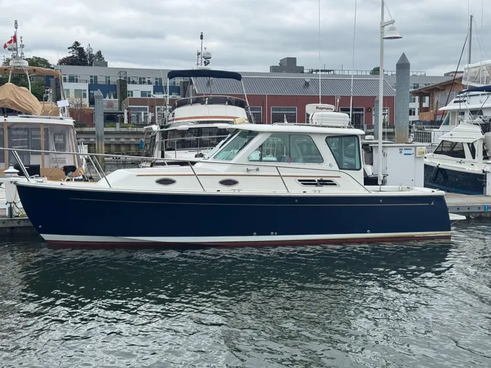 Change Of Pace Yacht Photos Pics 2008 Back Cove 29 Hardback boat docked in a marina, featuring a sleek blue hull.