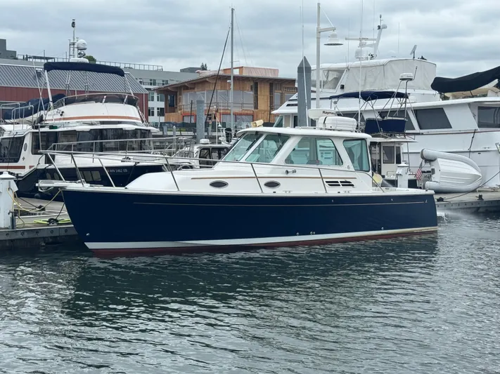 Change Of Pace Yacht Photos Pics 2008 Back Cove 29 Hardback boat docked in a marina, surrounded by other vessels.