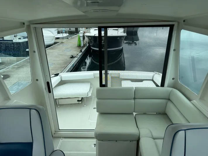 Change Of Pace Yacht Photos Pics 2008 Back Cove 29 Hardback interior with seating, docked at marina.