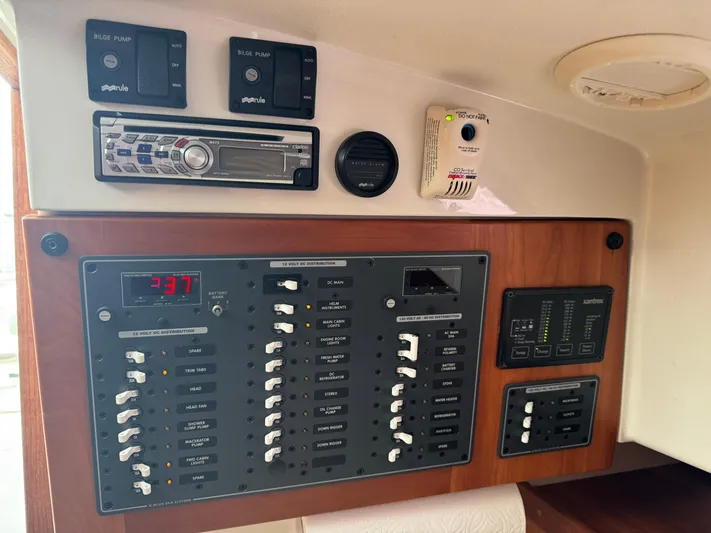 Change Of Pace Yacht Photos Pics Electrical control panel of a 2008 Back Cove 29 Hardback boat, featuring switches and stereo system.