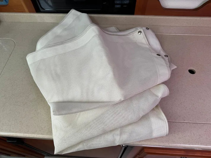 Change Of Pace Yacht Photos Pics Folded white fabric with grommets on a countertop, possibly for a 2008 Back Cove 29 Hardback.