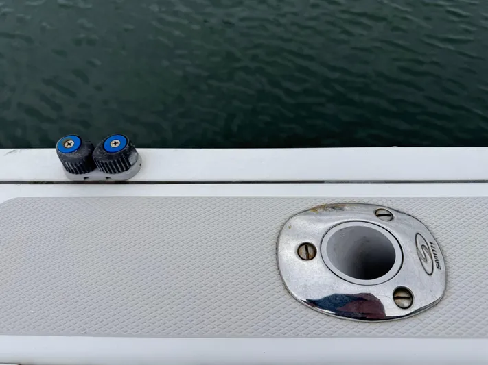 Change Of Pace Yacht Photos Pics 2008 Back Cove 29 Hardback boat detail with rod holder and water backdrop.