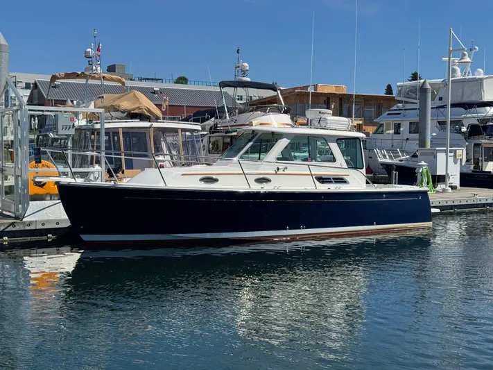 Change Of Pace Yacht Photos Pics 2008 Back Cove 29 Hardback boat docked in a marina under clear blue skies.