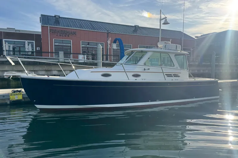 Change Of Pace Yacht Photos Pics 2008 Back Cove 29 Hardback boat docked near Fisherman building.