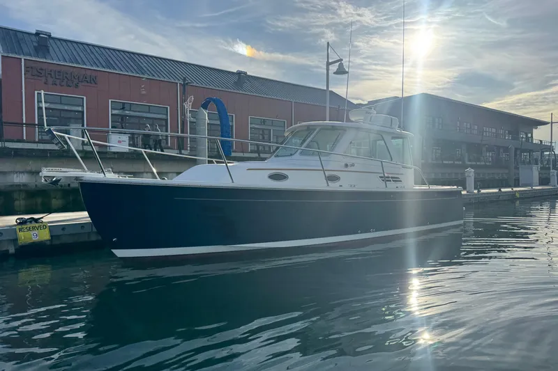 Change Of Pace Yacht Photos Pics 2008 Back Cove 29 Hardback boat docked at marina with sunlit reflections.