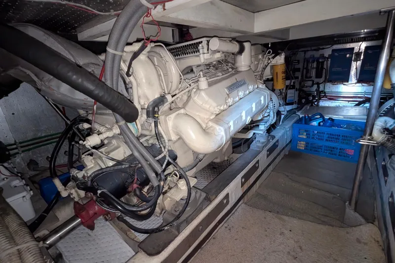 Fisher Folly IV Yacht Photos Pics Engine room of 1988 Offshore Yachts 48 Yachtfisher, showcasing detailed machinery and components.