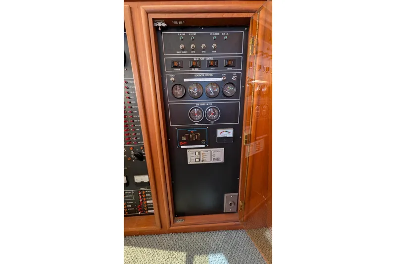 Fisher Folly IV Yacht Photos Pics Control panel of 1988 Offshore Yachts 48 Yachtfisher, featuring gauges and switches.