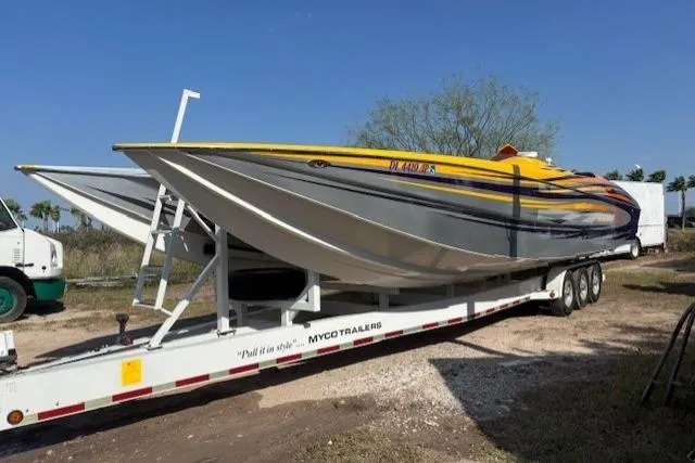  Yacht Photos Pics 2008 Nor-Tech 3600 Supercat on trailer, vibrant yellow and purple design, parked outdoors.