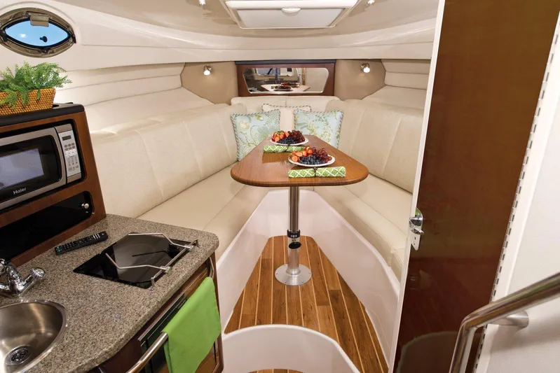  Yacht Photos Pics Manufacturer Provided Image: Interior of 2015 Robalo R305 Walkaround boat with dining area and kitchenette.