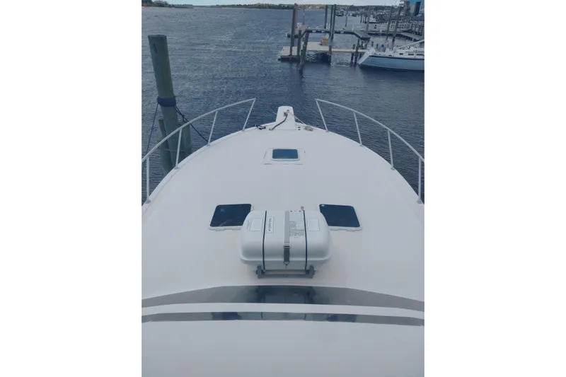  Yacht Photos Pics Bow view of a 1999 Viking 45 Convertible yacht docked at a marina.