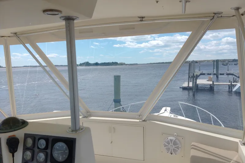  Yacht Photos Pics View from 1999 Viking 45 Convertible yacht cockpit overlooking calm waters and dock.