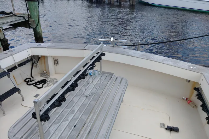  Yacht Photos Pics 1999 Viking 45 Convertible boat deck with fishing rod holders and dock view.