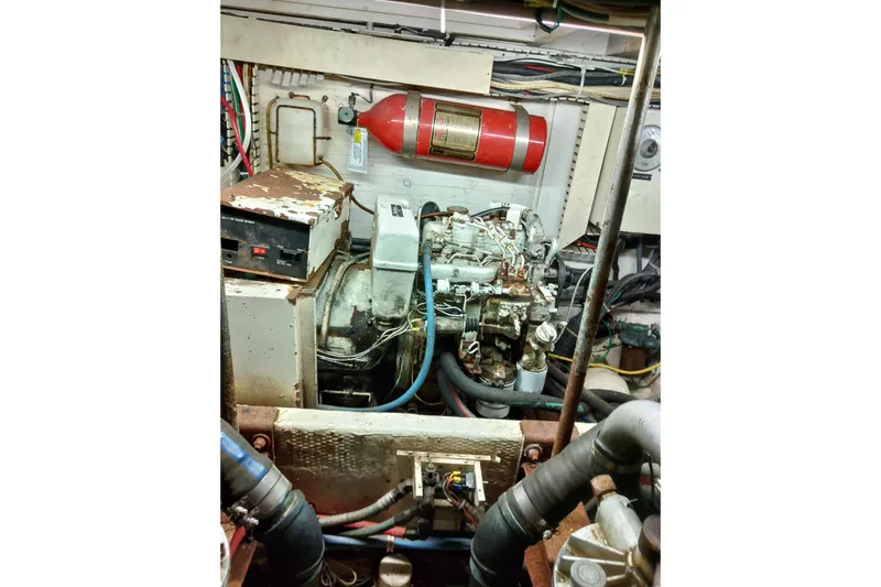  Yacht Photos Pics Engine room of a 1999 Viking 45 Convertible boat with visible machinery and fire extinguisher.