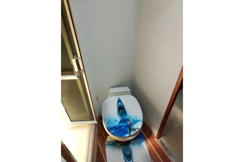  Yacht Photos Pics Toilet with shark-themed seat cover on 1999 Viking 45 Convertible yacht.