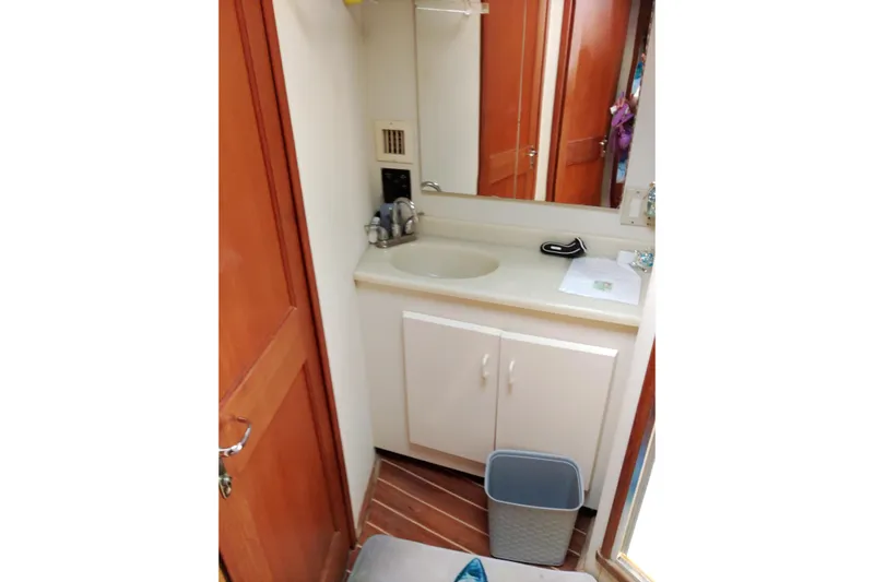  Yacht Photos Pics Bathroom interior of 1999 Viking 45 Convertible yacht with sink and mirror.