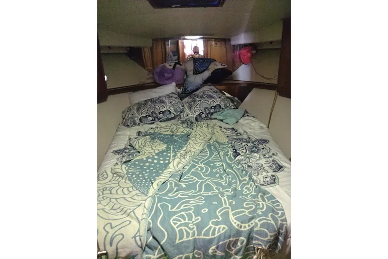  Yacht Photos Pics Cozy cabin bedroom in a 1999 Viking 45 Convertible boat with patterned bedding.