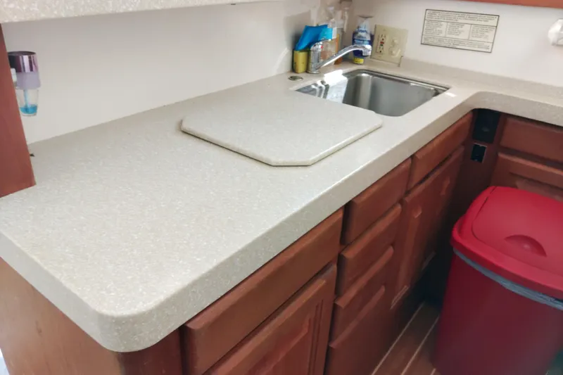  Yacht Photos Pics 1999 Viking 45 Convertible kitchen with sink, countertop, and red trash bin.