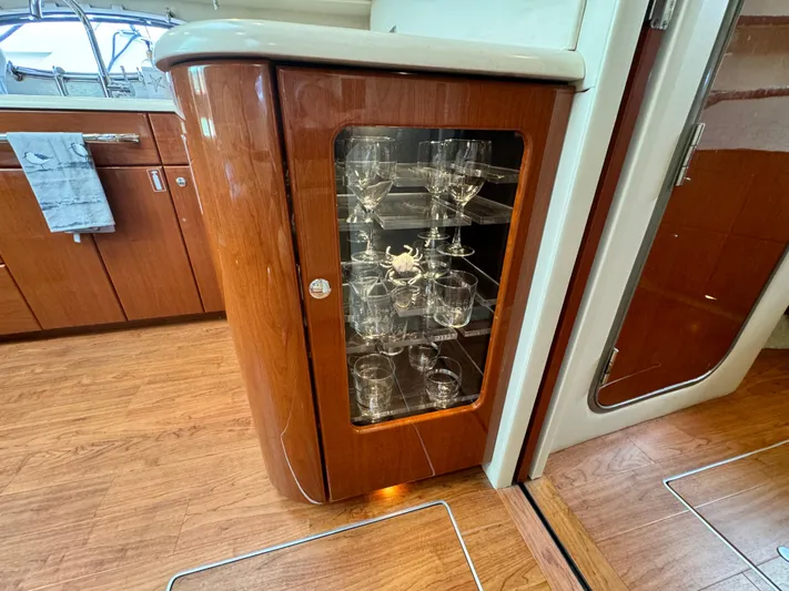 Lovely Day Yacht Photos Pics 2009 Formula 45 Yacht interior with glass cabinet and wooden flooring.