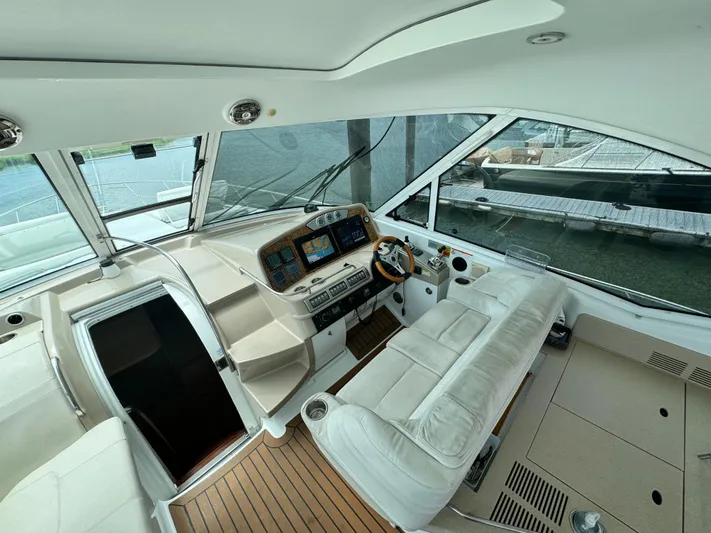 Lovely Day Yacht Photos Pics 2009 Formula 45 Yacht cockpit with modern controls, white seating, and wood flooring.