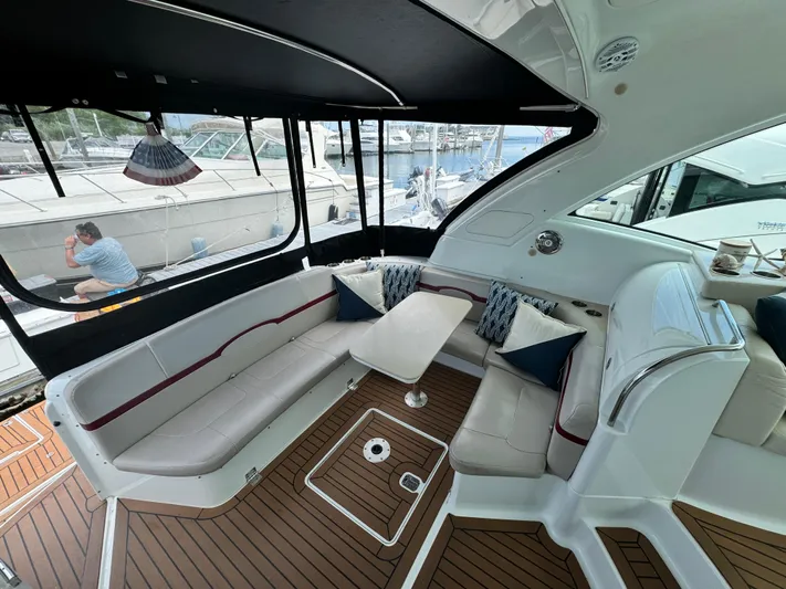 Lovely Day Yacht Photos Pics 2009 Formula 45 Yacht interior with elegant seating and wooden flooring at a marina.