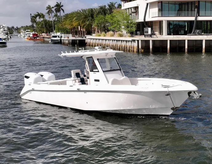  Yacht Photos Pics 2013 Everglades 325 Center Console boat cruising near waterfront homes.