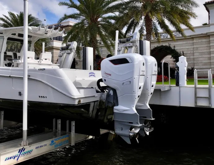  Yacht Photos Pics 2013 Everglades 325 Center Console boat with twin outboard engines docked near palm trees.