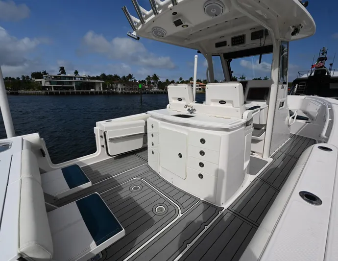  Yacht Photos Pics 2013 Everglades 325 Center Console boat interior with seating and storage, docked by waterfront homes.
