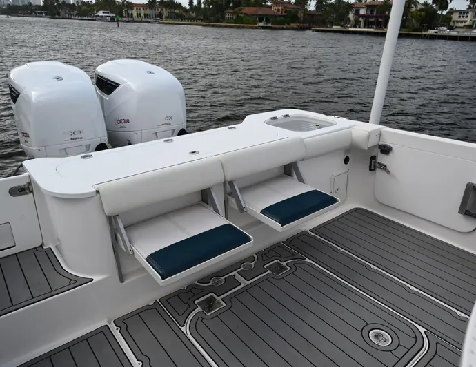  Yacht Photos Pics 2013 Everglades 325 Center Console boat with dual engines and foldable seating on deck.