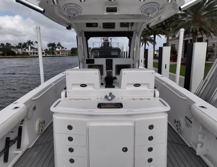  Yacht Photos Pics 2013 Everglades 325 Center Console boat interior with helm and seating, docked by waterfront homes.
