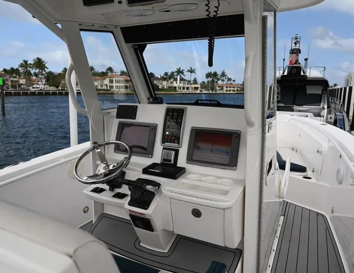  Yacht Photos Pics 2013 Everglades 325 Center Console boat interior with steering wheel and navigation screens.