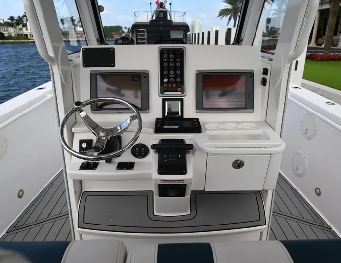  Yacht Photos Pics 2013 Everglades 325 Center Console boat dashboard with steering wheel and navigation screens.