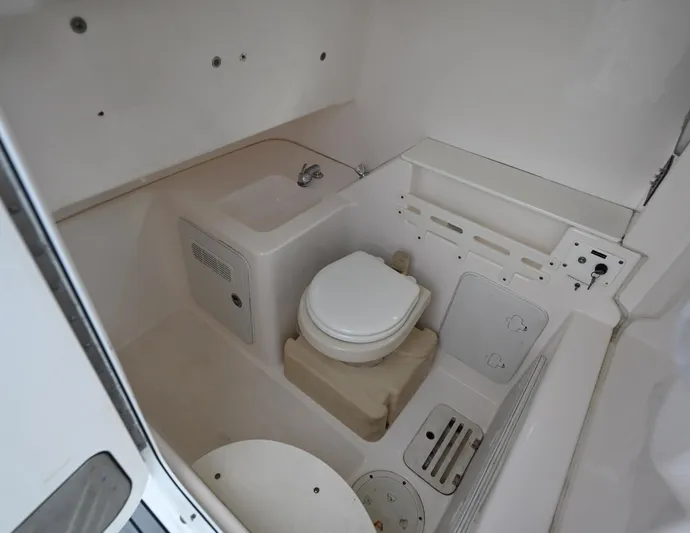  Yacht Photos Pics Interior of 2013 Everglades 325 Center Console boat with compact bathroom amenities.