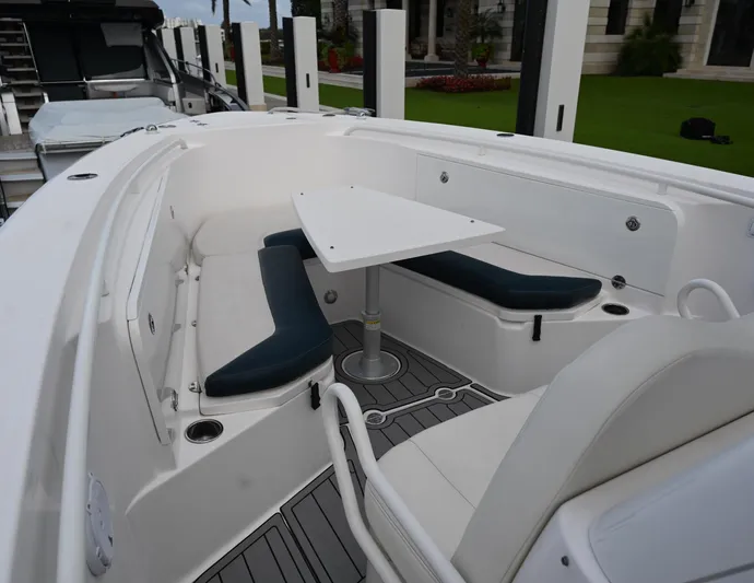  Yacht Photos Pics 2013 Everglades 325 Center Console boat with seating area and table.