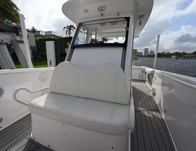  Yacht Photos Pics 2013 Everglades 325 Center Console boat with white seating and waterfront view.