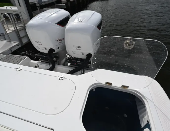  Yacht Photos Pics 2013 Everglades 325 Center Console with twin outboard engines, docked by the water.