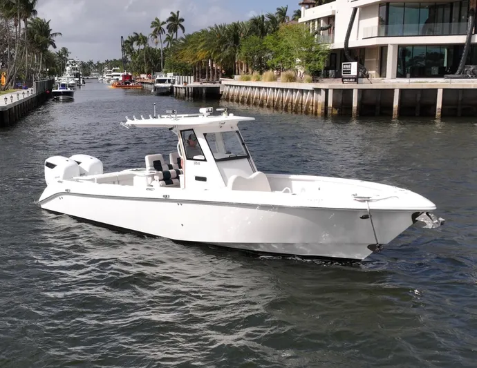  Yacht Photos Pics 2013 Everglades 325 Center Console boat cruising on a scenic waterway.
