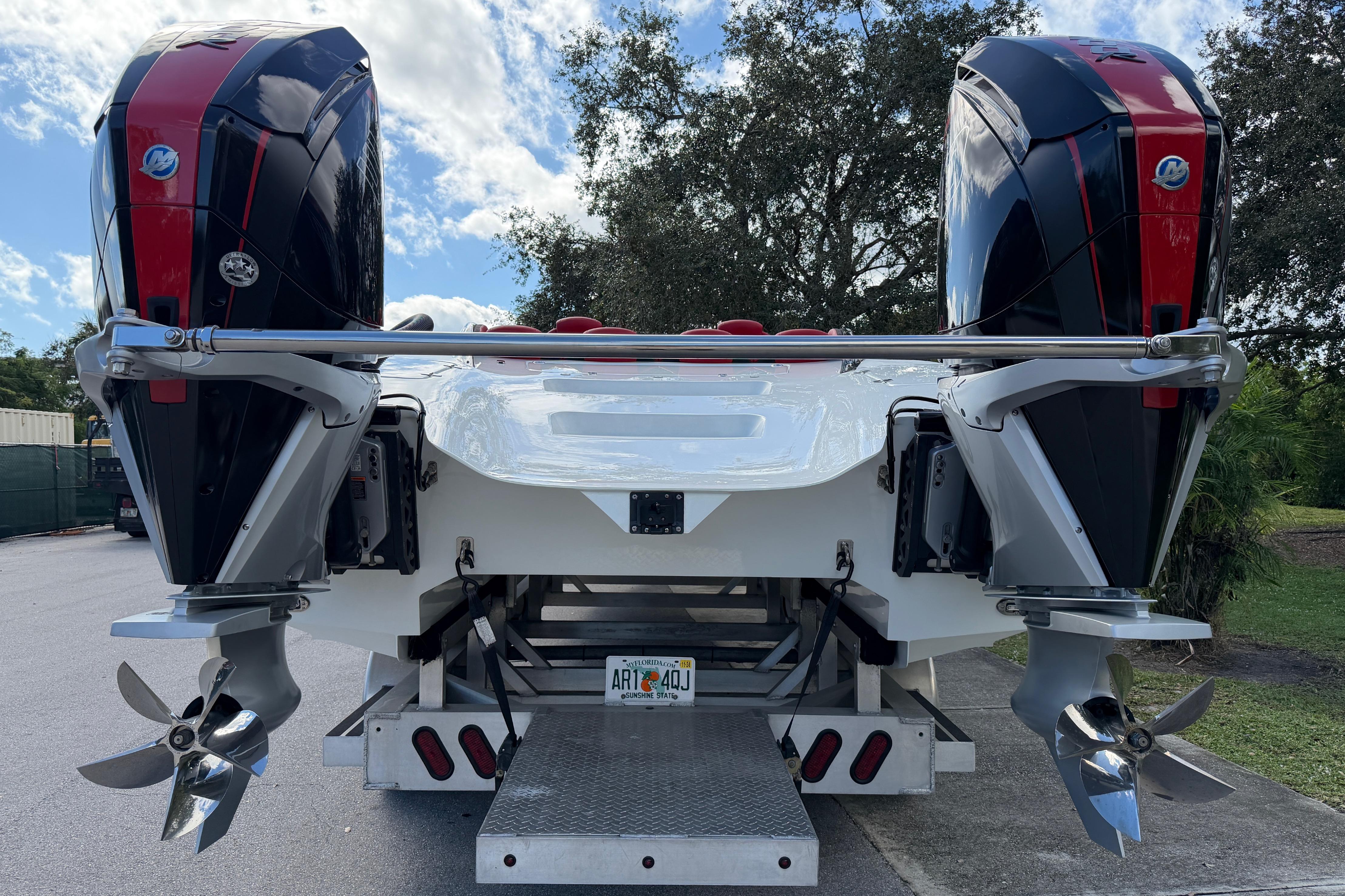 2022 Doug Wright 320 boat with dual outboard engines, parked outdoors.