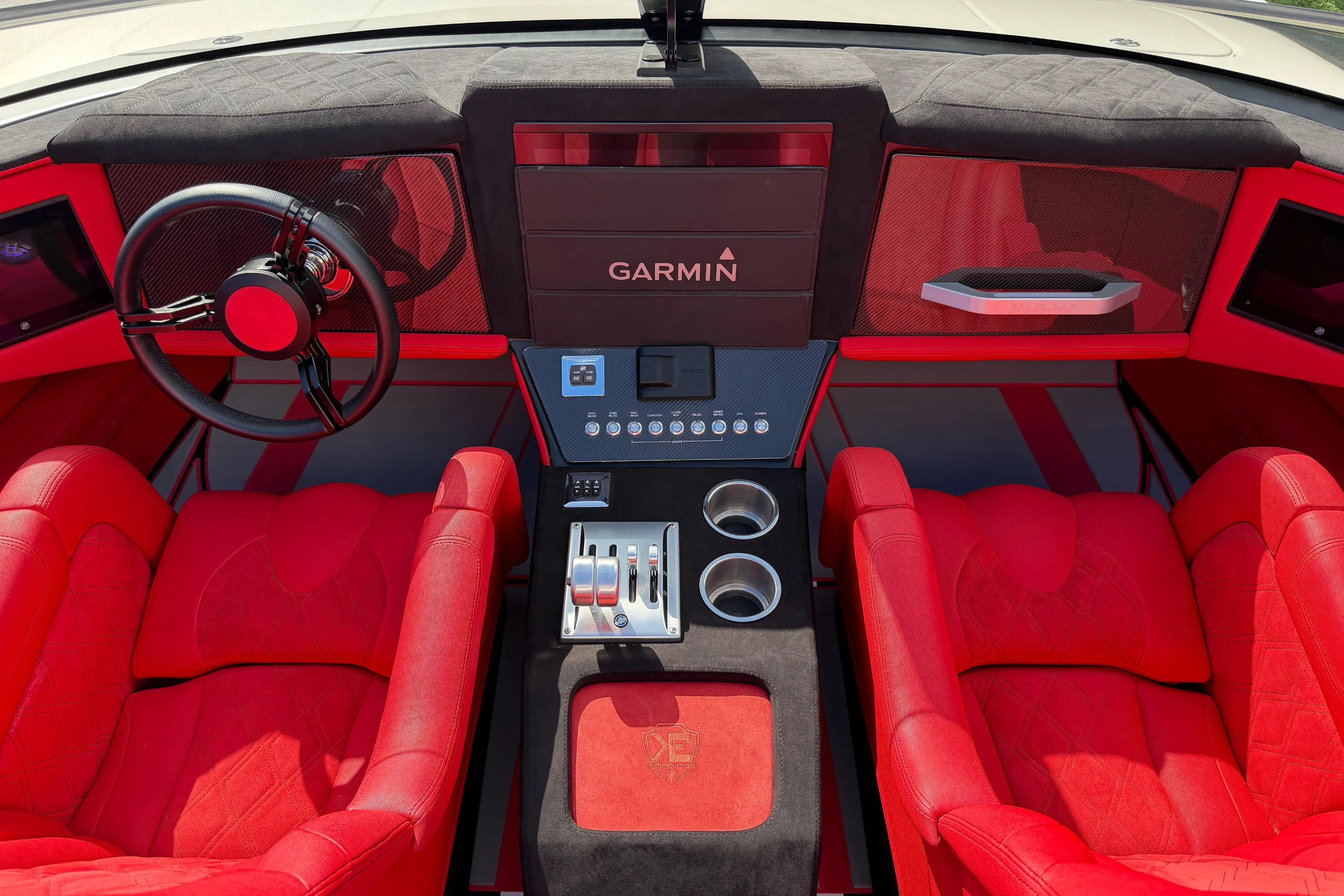 Red interior of 2022 Doug Wright 320 boat with Garmin navigation system.