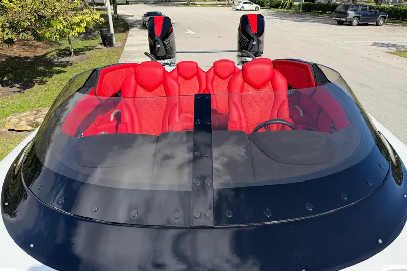  Yacht Photos Pics 2022 Doug Wright 320 boat with red interior and dual engines in a parking area.